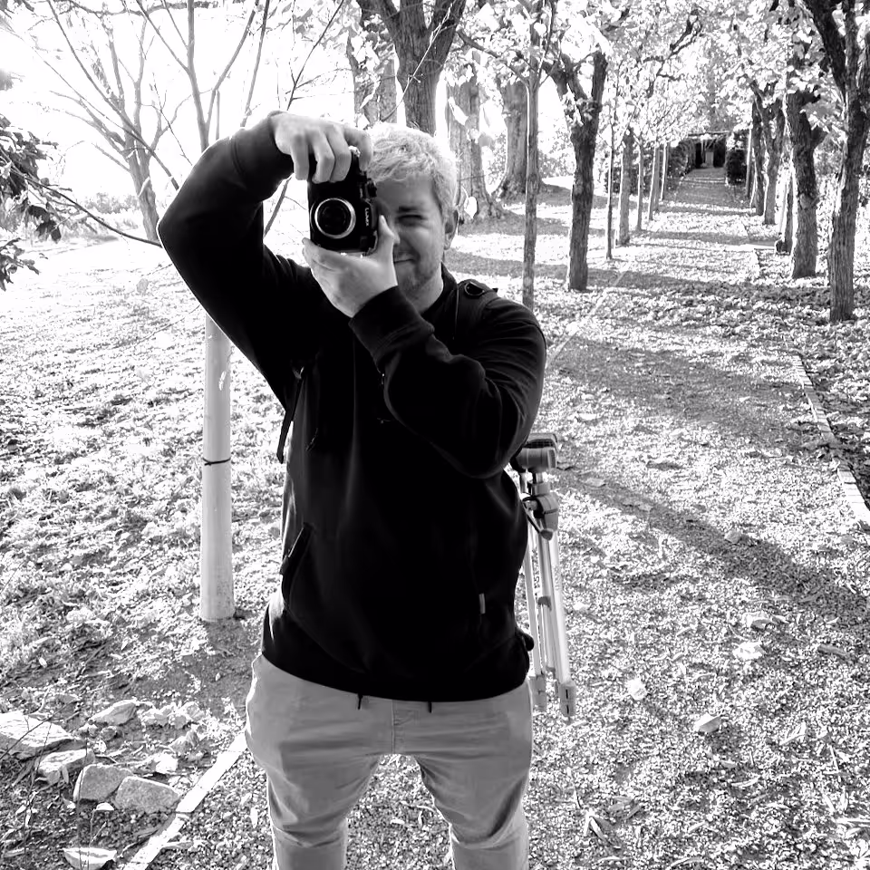 image of rhys holding a camera in black and white